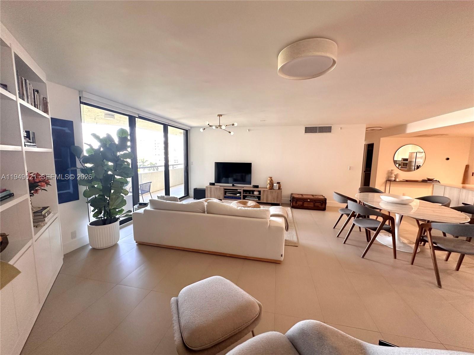 170 Ocean Ln Drive, Unit 809 Key Biscayne, FL 33149 - Photo 4 of 31 a living room with furniture and a flat screen tv