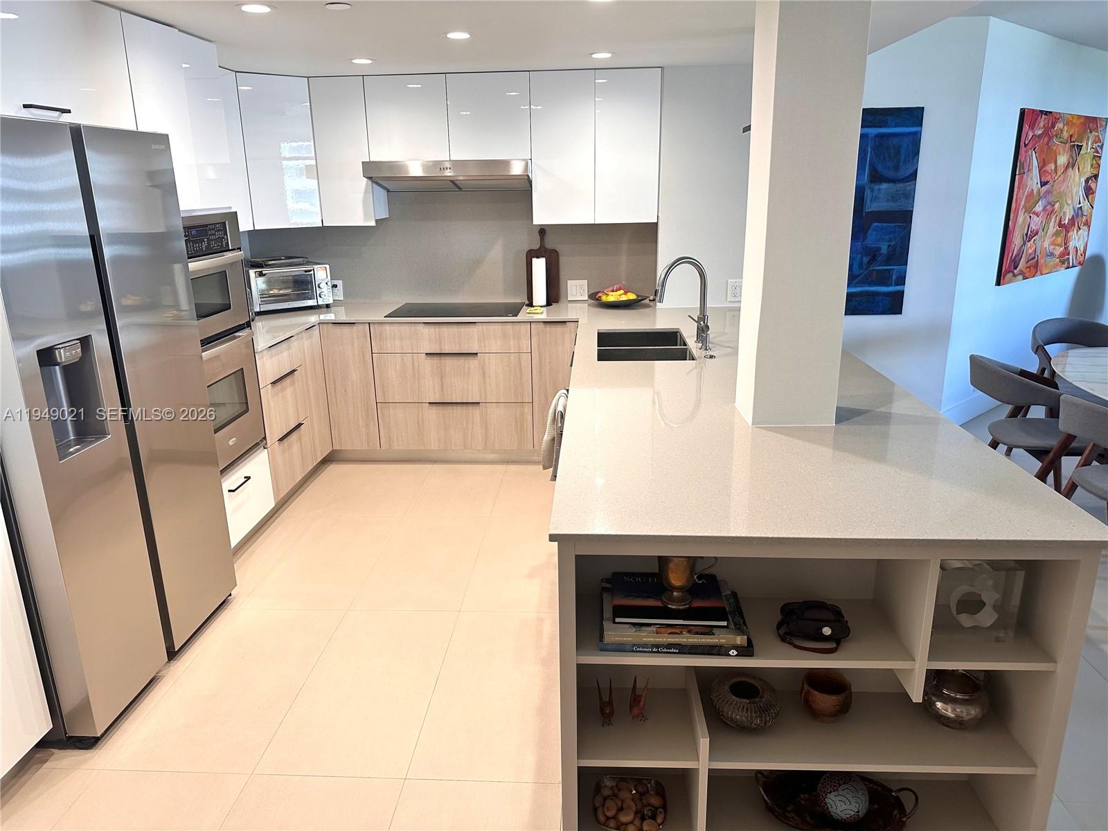 170 Ocean Ln Drive, Unit 809 Key Biscayne, FL 33149 - Photo 8 of 31 a kitchen with stainless steel appliances a sink a stove a refrigerator cabinets and a counter top space