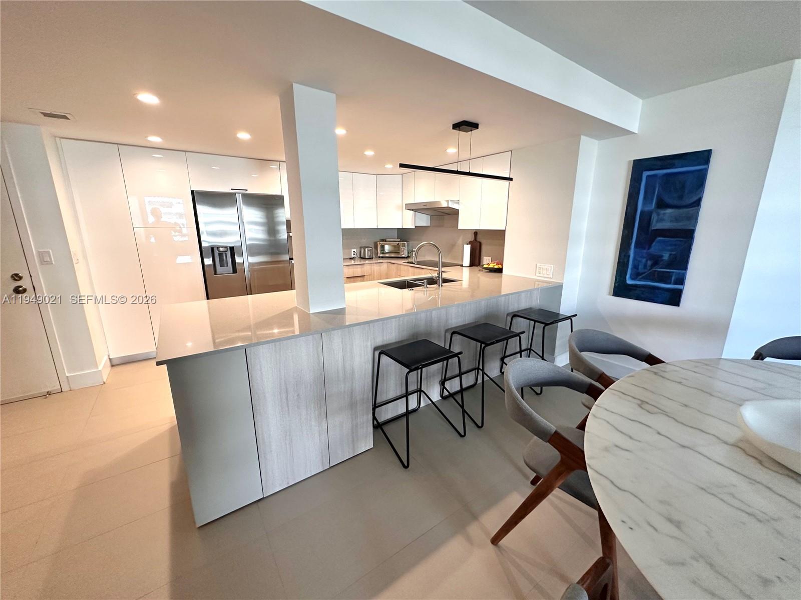 170 Ocean Ln Drive, Unit 809 Key Biscayne, FL 33149 - Photo 10 of 31 a dining room with furniture and a view of kitchen