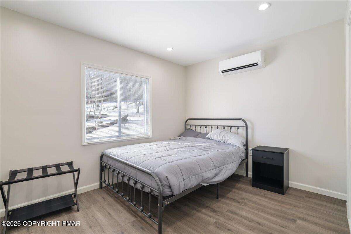 5873 Decker Road Bushkill, PA 18324 - Photo 15 of 57 a bedroom with a bed table and a window
