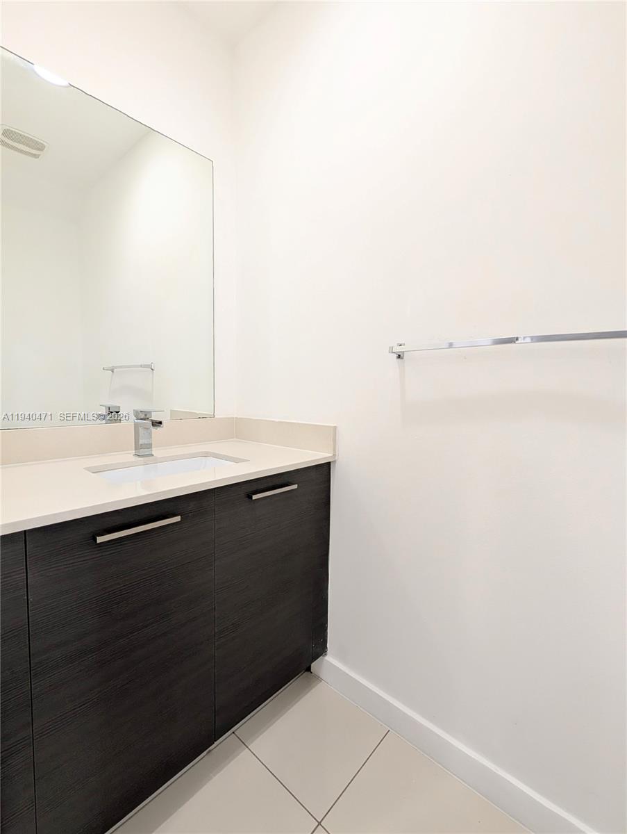 3484 Northwest 13th Street, Unit 3484 Lauderhill, FL 33311 - Photo 11 of 49 a bathroom with a sink and a mirror