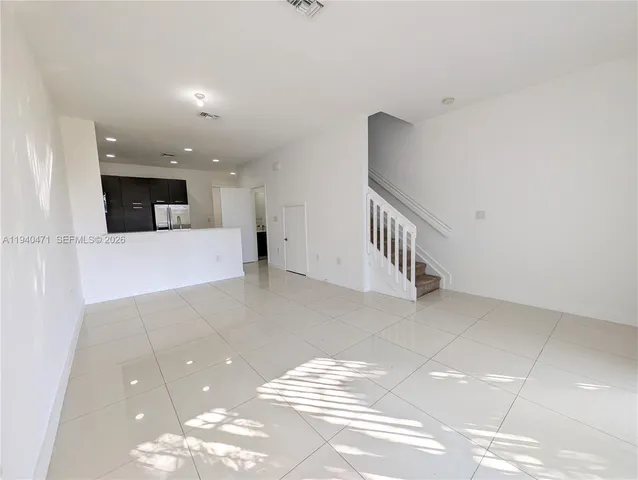 a view of a livingroom with kitchen and furniture
