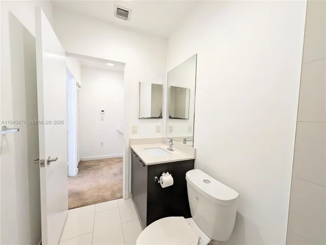 a white toilet sitting next to a bathroom sink