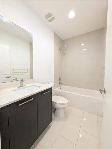 a bathroom with a sink a toilet and bathtub