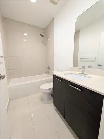 a bathroom with a sink a toilet and bathtub
