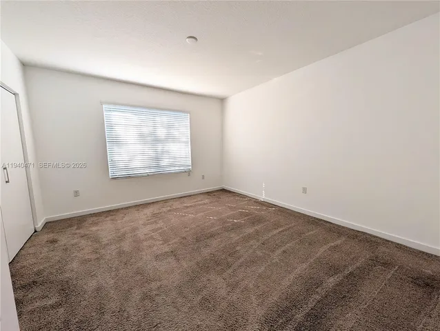 an empty room with a empty space and windows