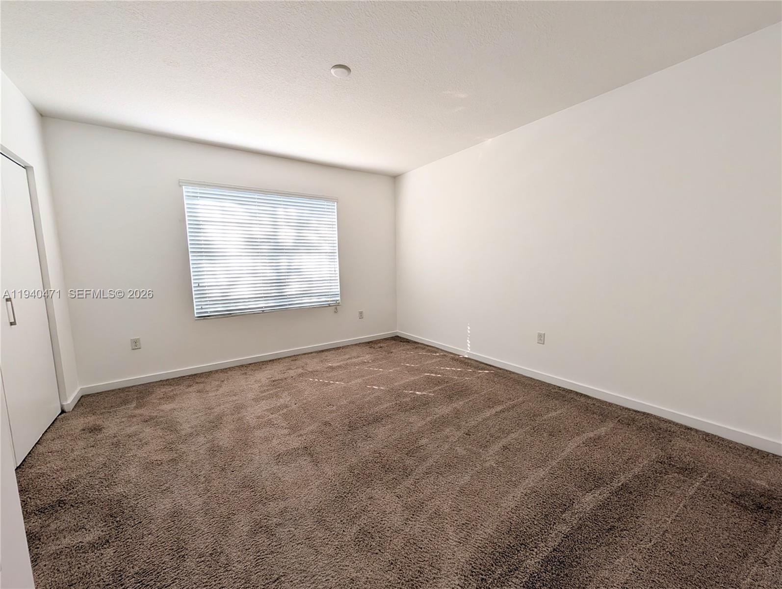 3484 Northwest 13th Street, Unit 3484 Lauderhill, FL 33311 - Photo 26 of 49 an empty room with a empty space and windows