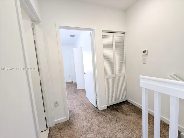a view of a bathroom with white door