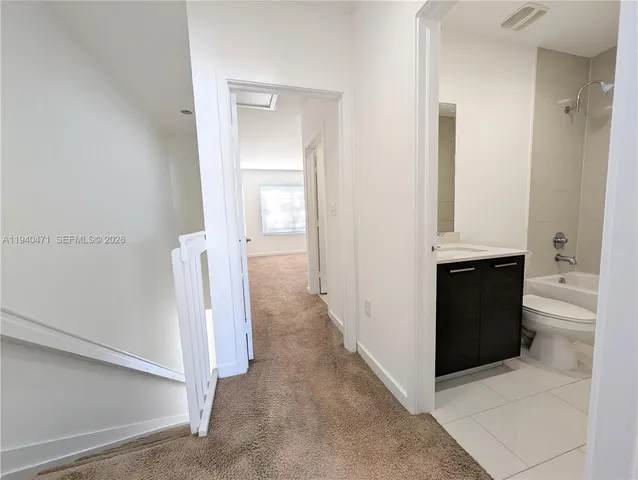 a view of staircase with white walls and a window