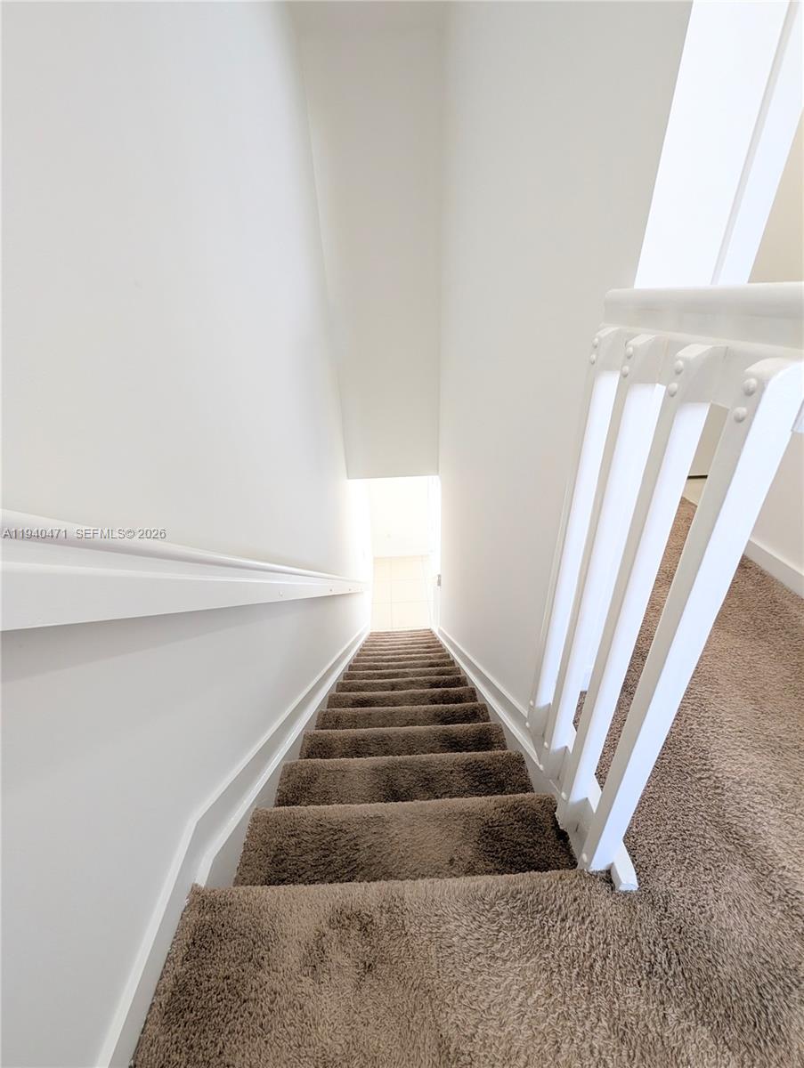3484 Northwest 13th Street, Unit 3484 Lauderhill, FL 33311 - Photo 32 of 49 a view of staircase with white walls and a window