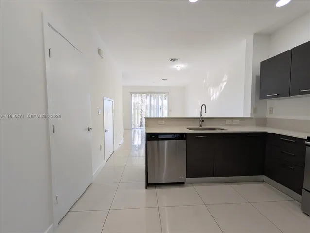 a view of balcony with chairs and potted plants