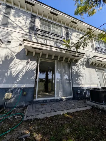 a view of a backyard with plants and a patio