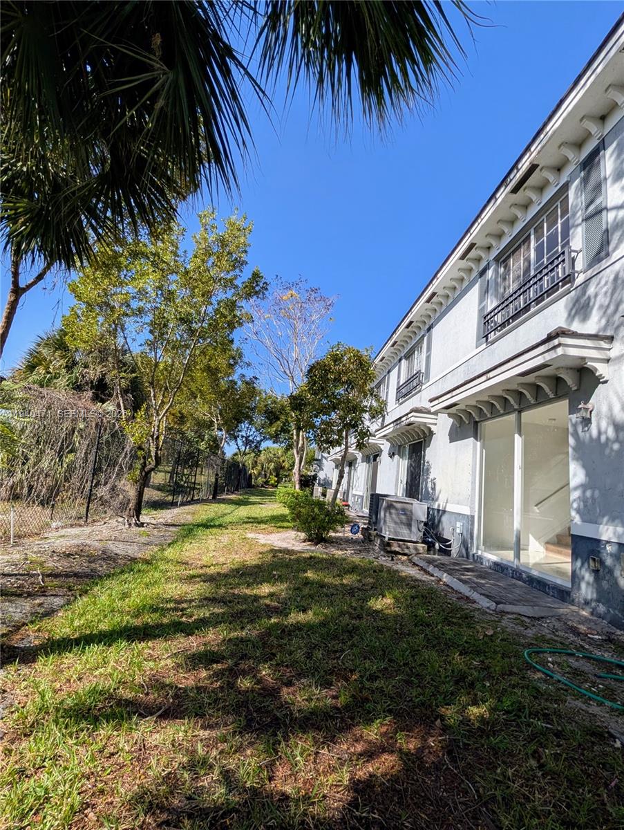 3484 Northwest 13th Street, Unit 3484 Lauderhill, FL 33311 - Photo 43 of 49 a backyard of a house with a garden and outdoor seating