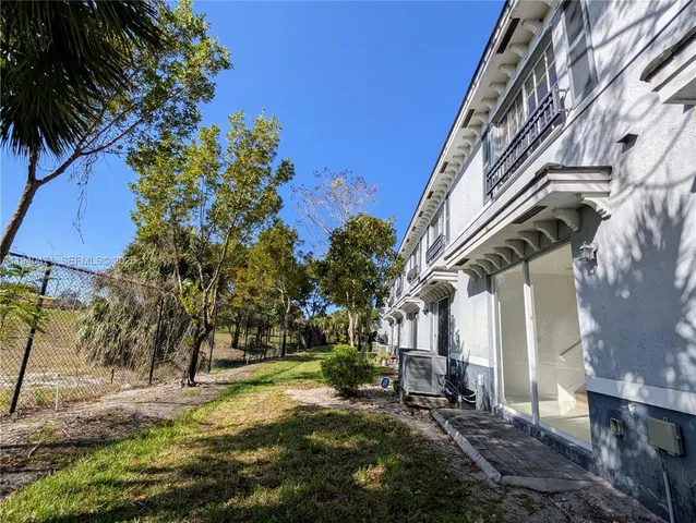 a view of a house with swimming pool and sitting area