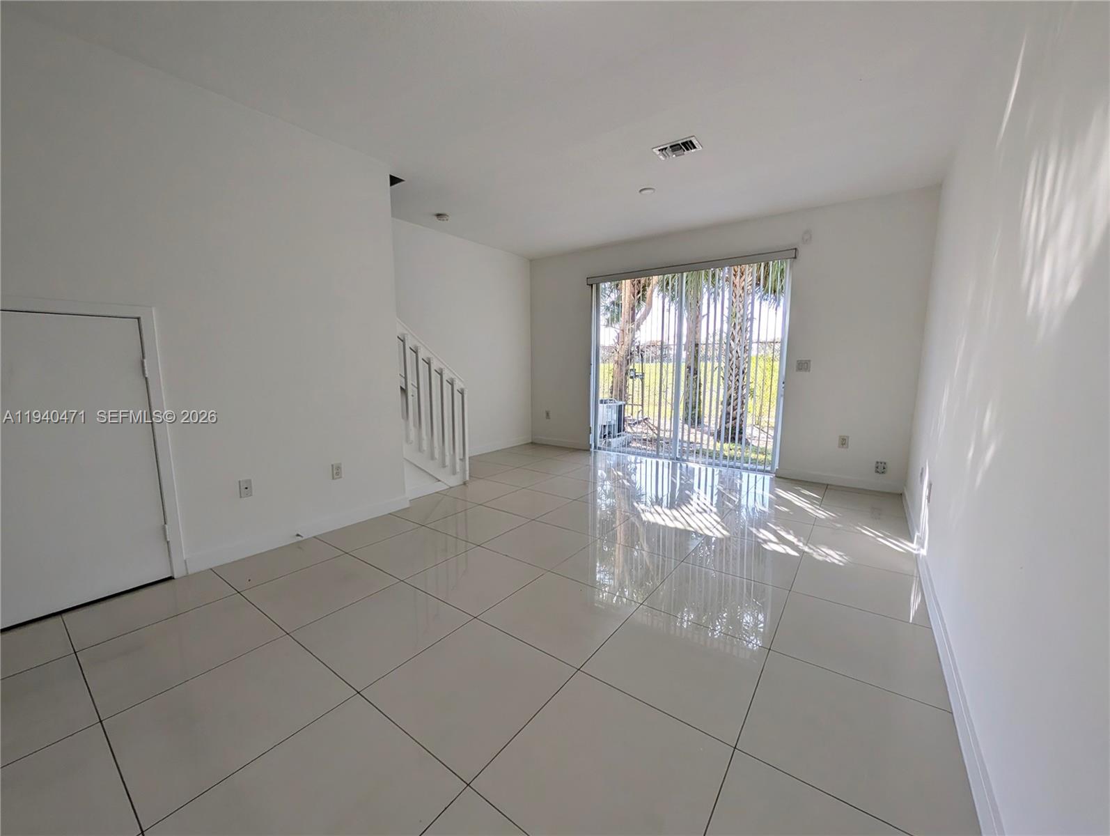 3484 Northwest 13th Street, Unit 3484 Lauderhill, FL 33311 - Photo 6 of 49 a view of an empty room with a fireplace