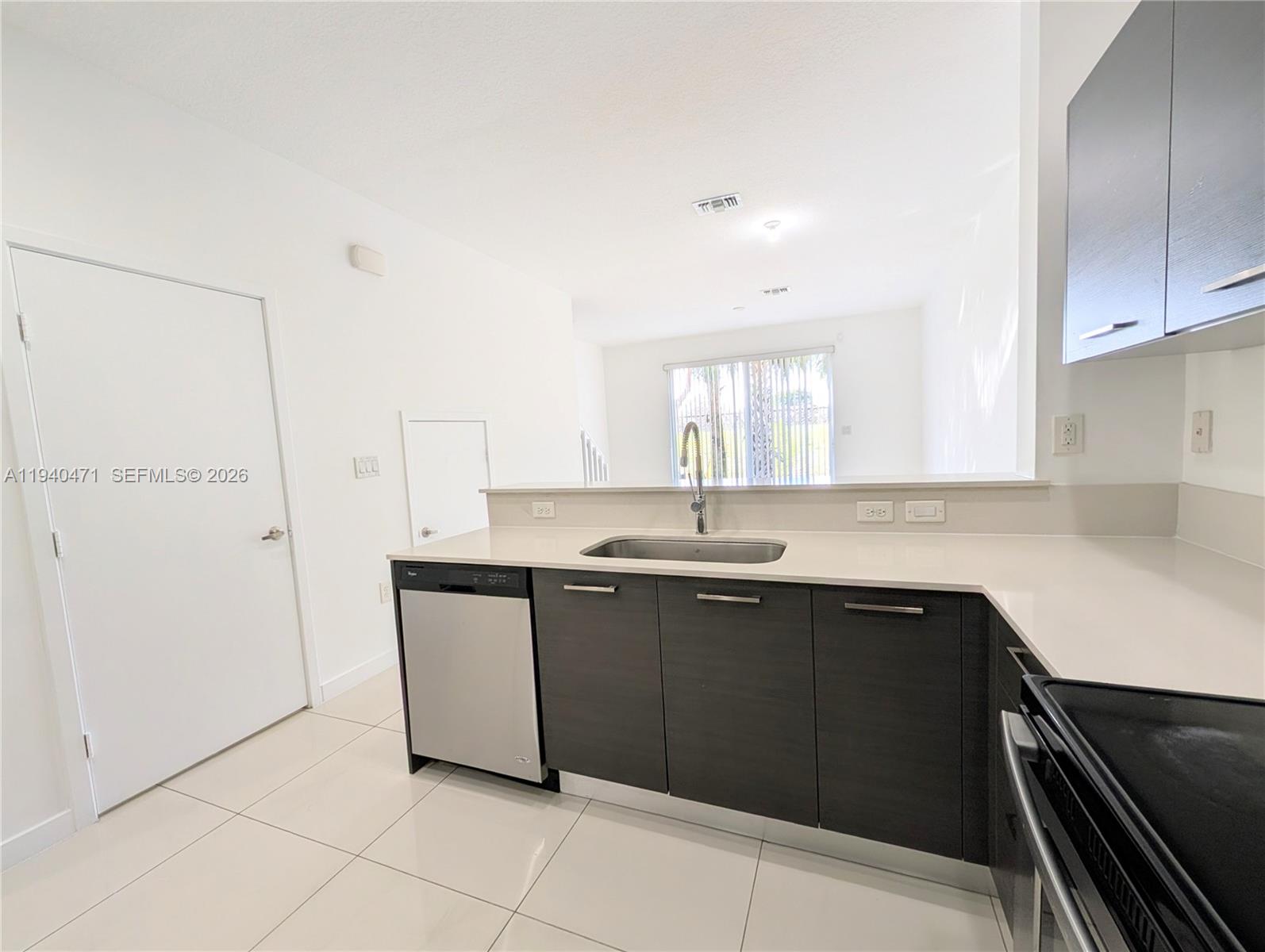 3484 Northwest 13th Street, Unit 3484 Lauderhill, FL 33311 - Photo 8 of 49 a kitchen with a sink and cabinets