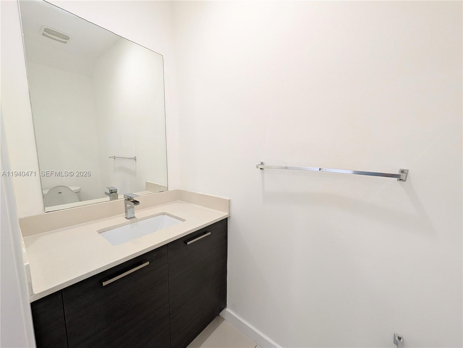 3484 Northwest 13th Street, Unit 3484 Lauderhill, FL 33311 - Photo 9 of 49 a bathroom with a sink and a mirror