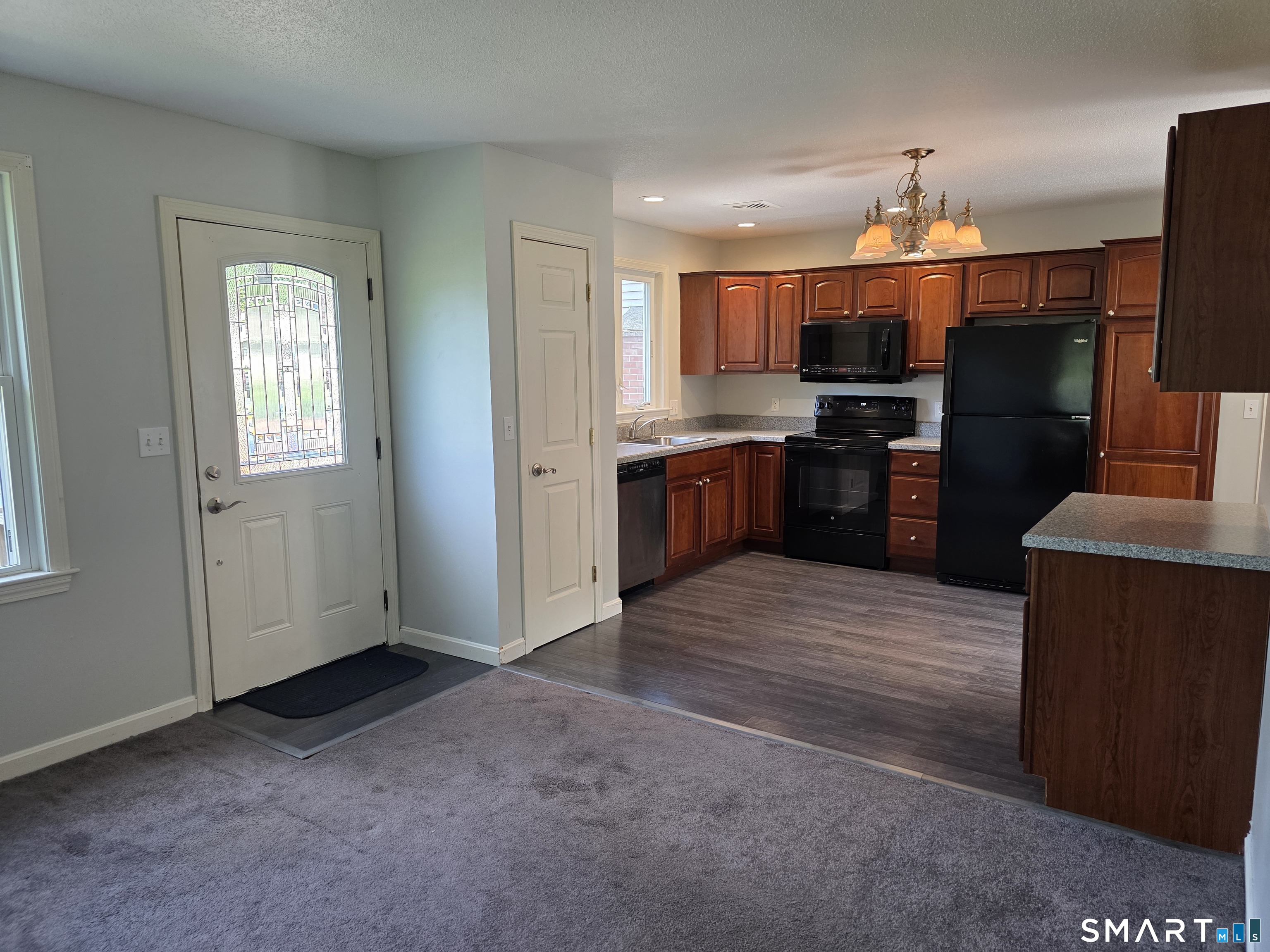 15 Van Buren Road Enfield, CT 06082 - Photo 35 of 40 a kitchen with kitchen island granite countertop a refrigerator stove top oven and sink