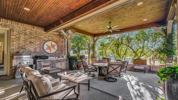 a view of a patio with table and chairs potted plants with wooden floor