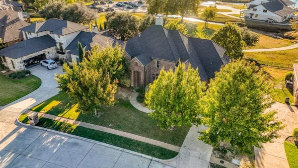an aerial view of a house with a yard basket ball court and outdoor seating