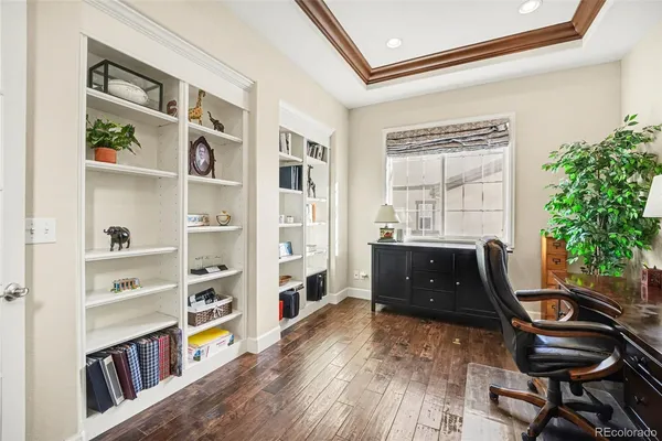 a view of a workspace with furniture and a window