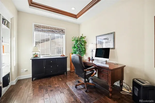 a view of a livingroom with furniture wooden floor table and a chandelier