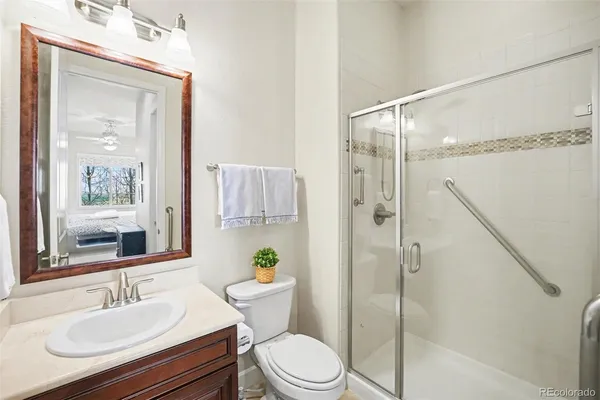 a bathroom with a tub sink and mirror