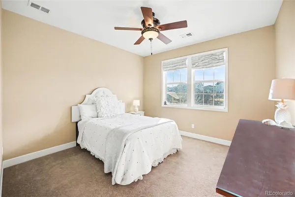a living room with furniture a chandelier and a flat screen tv