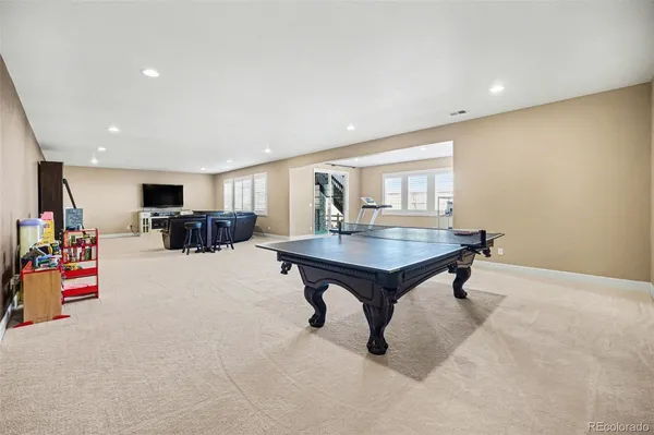 a bathroom with a granite countertop sink a toilet and a mirror