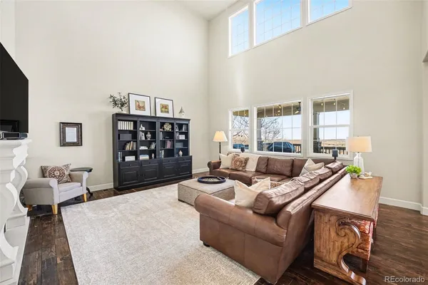 a kitchen with stainless steel appliances a dining table chairs and wooden floor