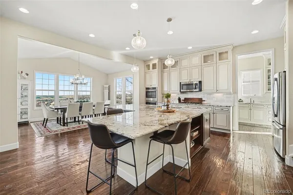 a kitchen with stainless steel appliances granite countertop wooden cabinets a sink and a stove