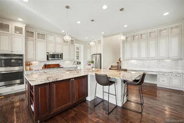 a kitchen with a sink stove and wooden cabinets