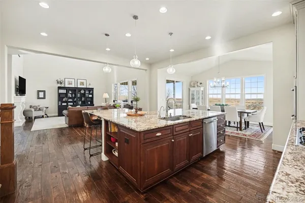 a dining room with furniture a rug and wooden floor
