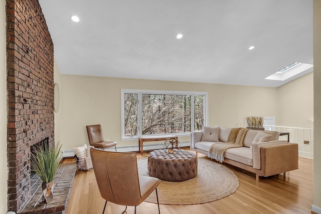 350 South Border Road Winchester, MA 01890 - Photo 3 of 30 a living room with furniture a fireplace and a floor to ceiling window