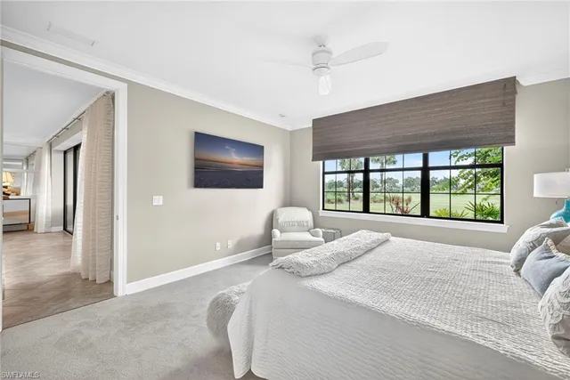 a bedroom with a large bed and a large window