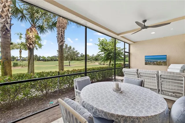 a view of a porch with furniture and a backyard