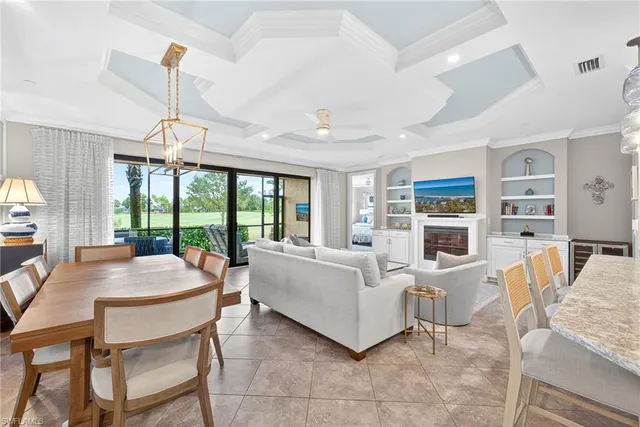 a living room with fireplace furniture and a large window