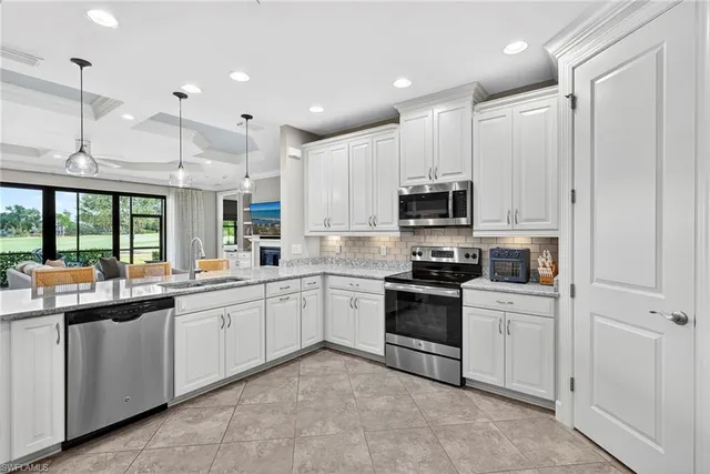 a kitchen with a sink stainless steel appliances and cabinets