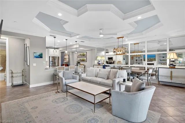 a living room with furniture and view of kitchen