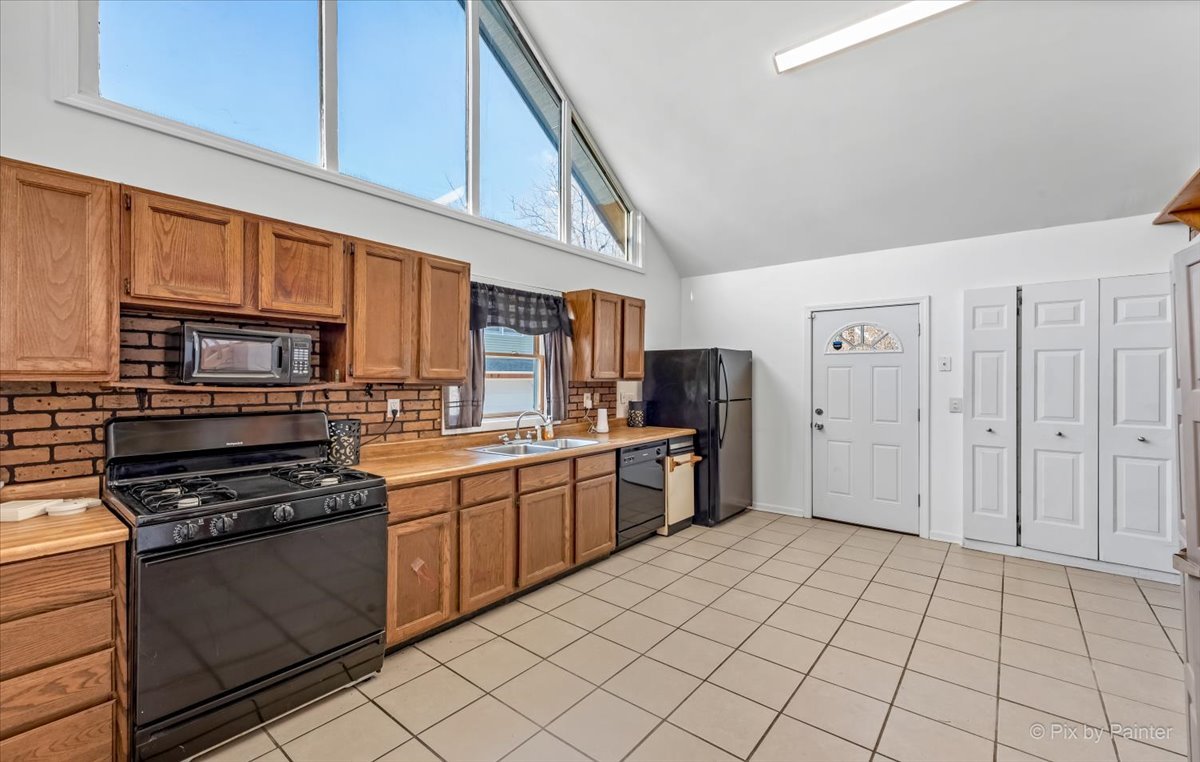 544 Hainesville Road Round Lake Park, IL 60073 - Photo 26 of 50 a kitchen with stainless steel appliances granite countertop a stove and a refrigerator