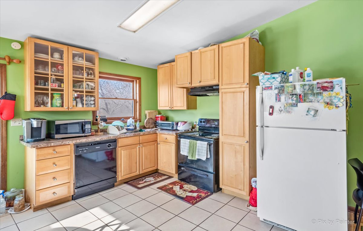 544 Hainesville Road Round Lake Park, IL 60073 - Photo 45 of 50 a kitchen with a refrigerator and a stove top oven