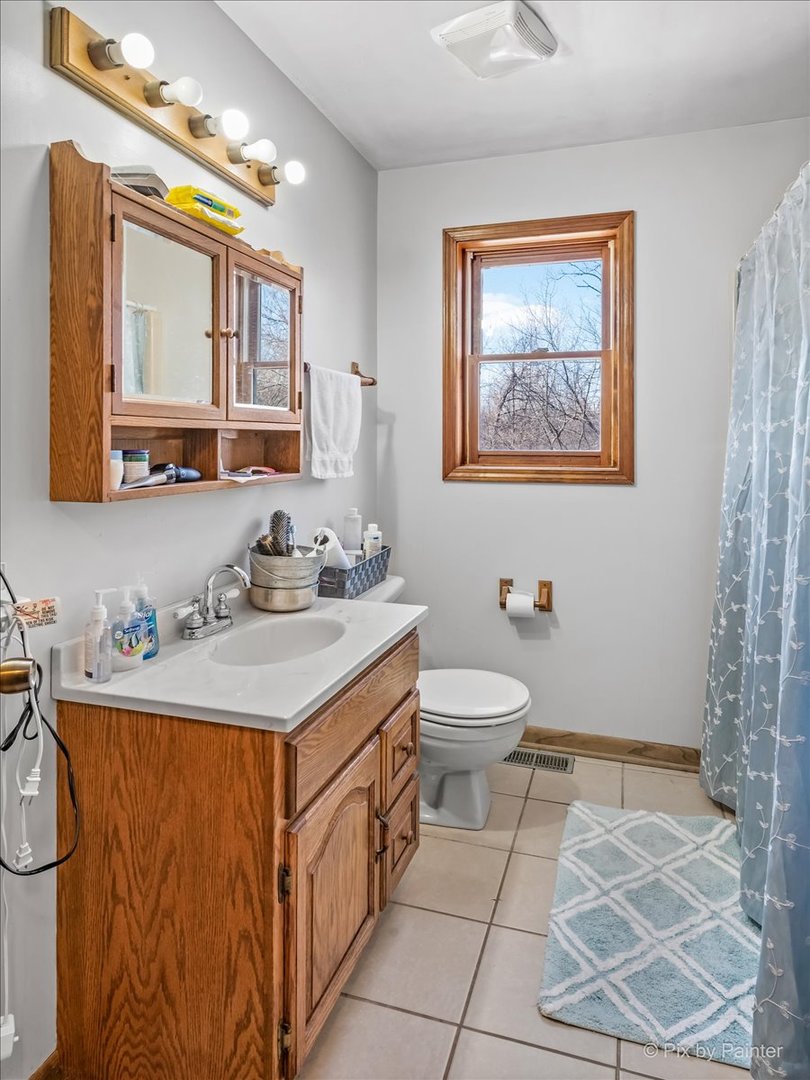 544 Hainesville Road Round Lake Park, IL 60073 - Photo 47 of 50 a bathroom with a sink a toilet and mirror