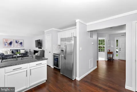 a kitchen with a refrigerator and a sink