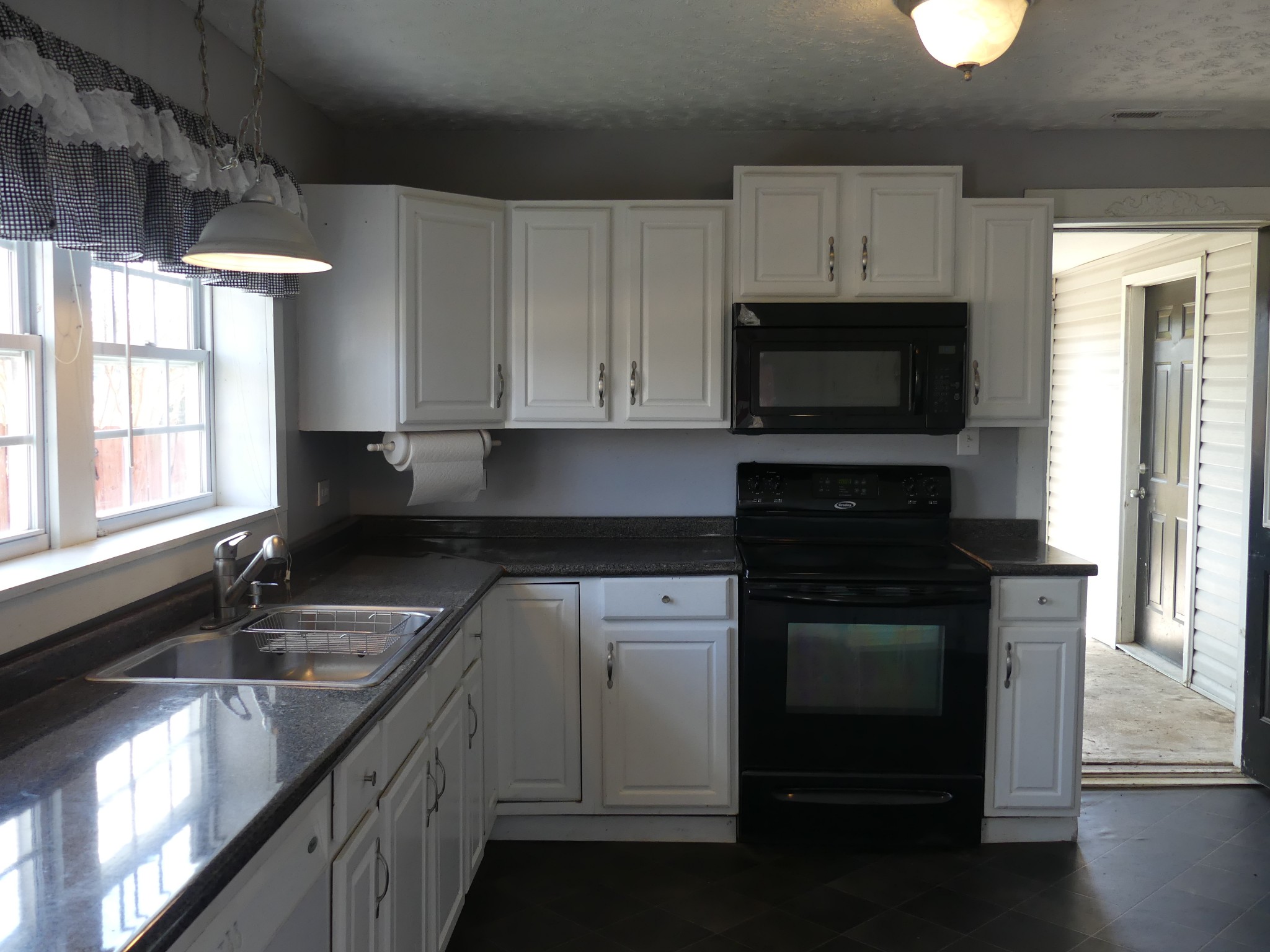 231 Mountain Road Elora, TN 37328 - Photo 12 of 32 a kitchen with granite countertop a sink stainless steel appliances and cabinets