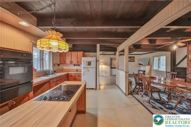 a kitchen with a sink a stove and a refrigerator
