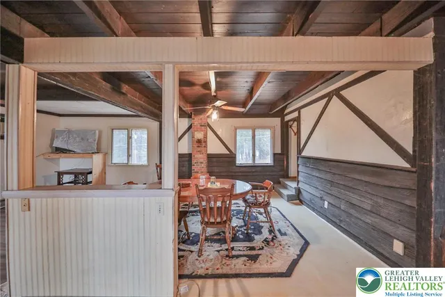 a dining room with furniture and a chandelier
