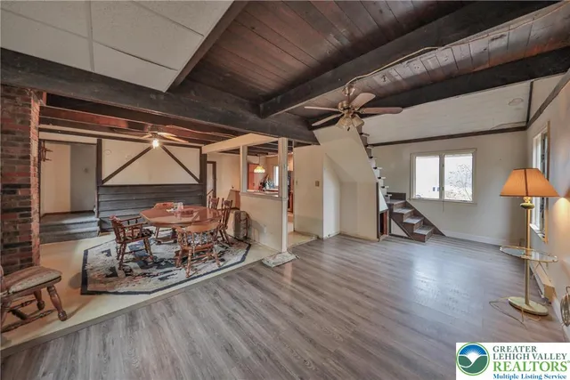 a living room with a couch wooden floor and a window