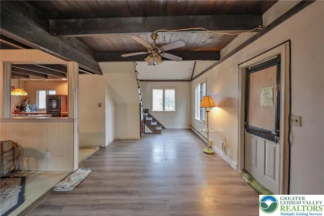 a en suite bathroom with a granite countertop sink a mirror and shower