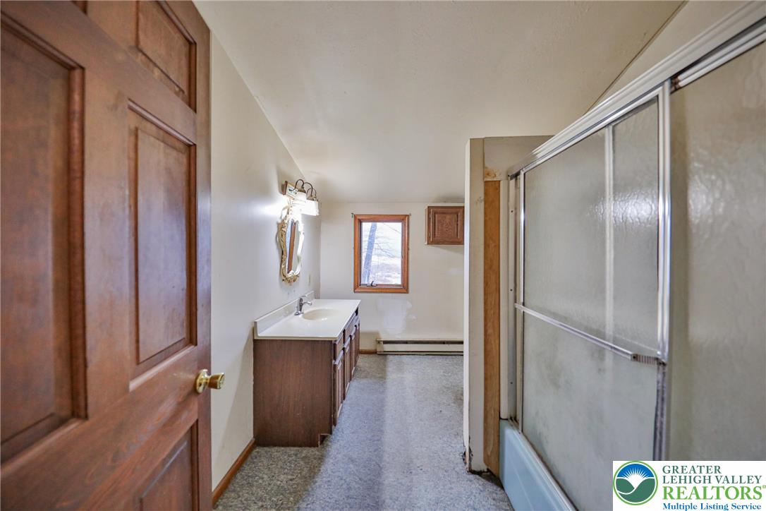 355 Hickory Road Palmerton, PA 18071 - Photo 38 of 66 a en suite bathroom with a granite countertop sink a mirror and shower