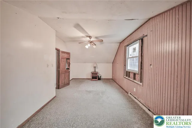 a view of a room with wooden walls